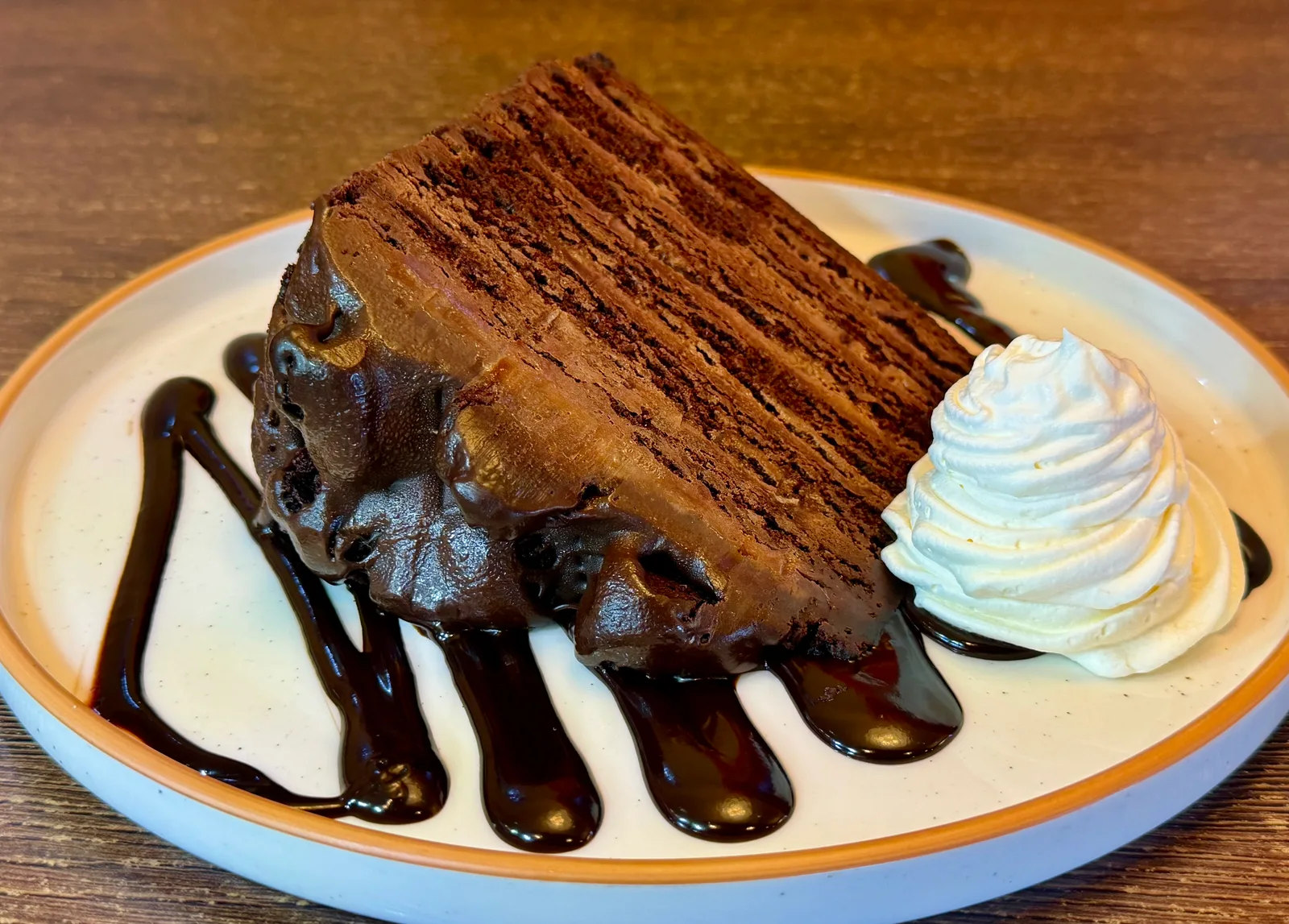 Decadent chocolate cake with a Ghiradelli chocolate sauce and whipped cream